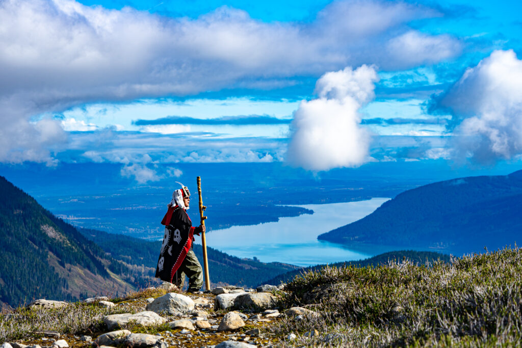 Photo of a Gitanyow Chief in regalia looking out over the territory